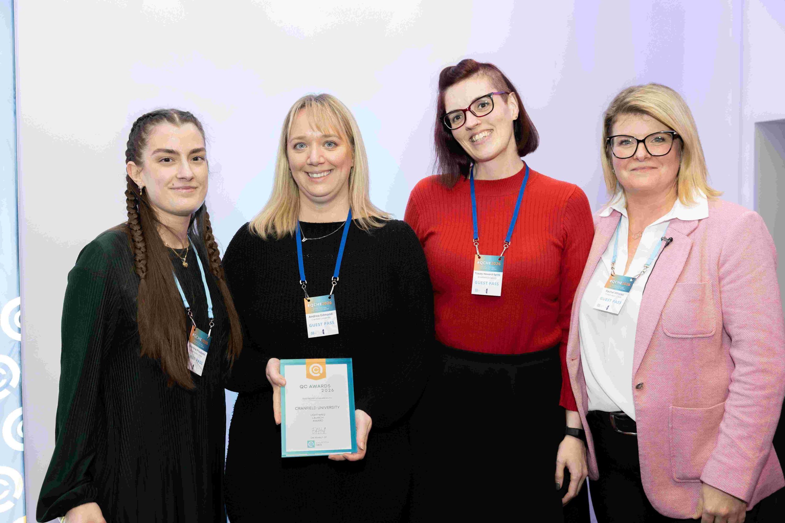 The cranfield university admissions team receiving an award from qualification check
